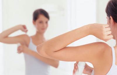 Woman Applying Deodorant On Her Armpits