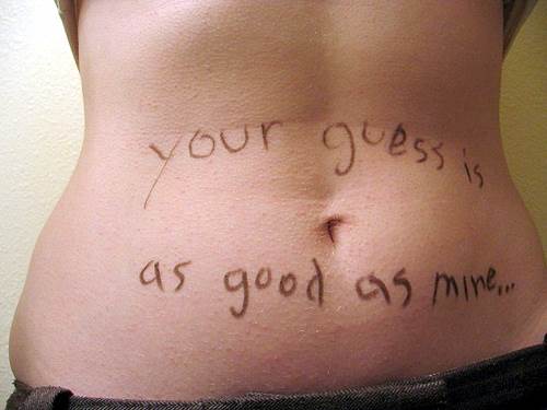 A Woman's Belly Inscribed with the Words "your guess is as good as mine..."