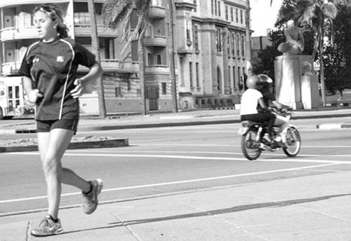 Girl Jogging on a City Street Sidewalk